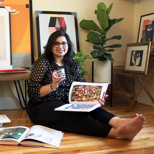 Ishita looking at an art book while sitting coffee