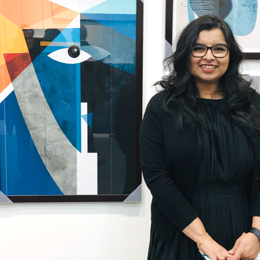 Ishita standing next to her original abstract art